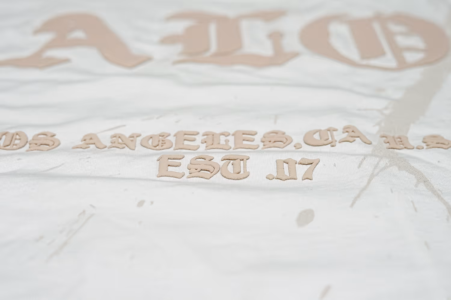 A close-up image of a puff screen print for ALO brand featuring bold puff letters..