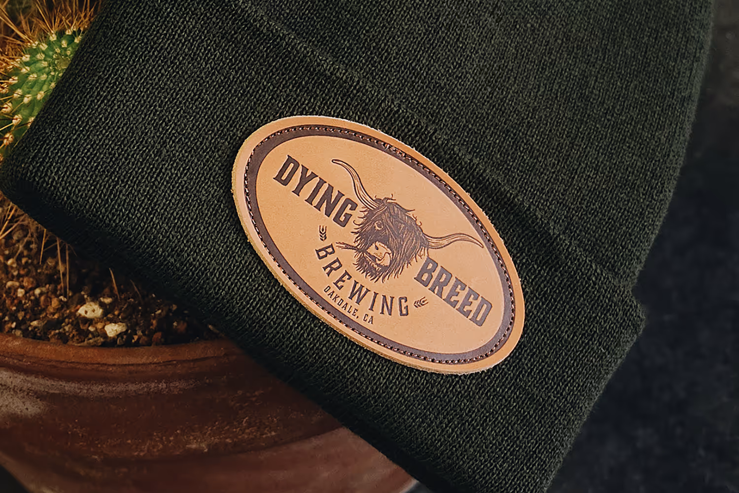 An image featuring a leather patch for Dying Breed Brewing applied to a beanie.