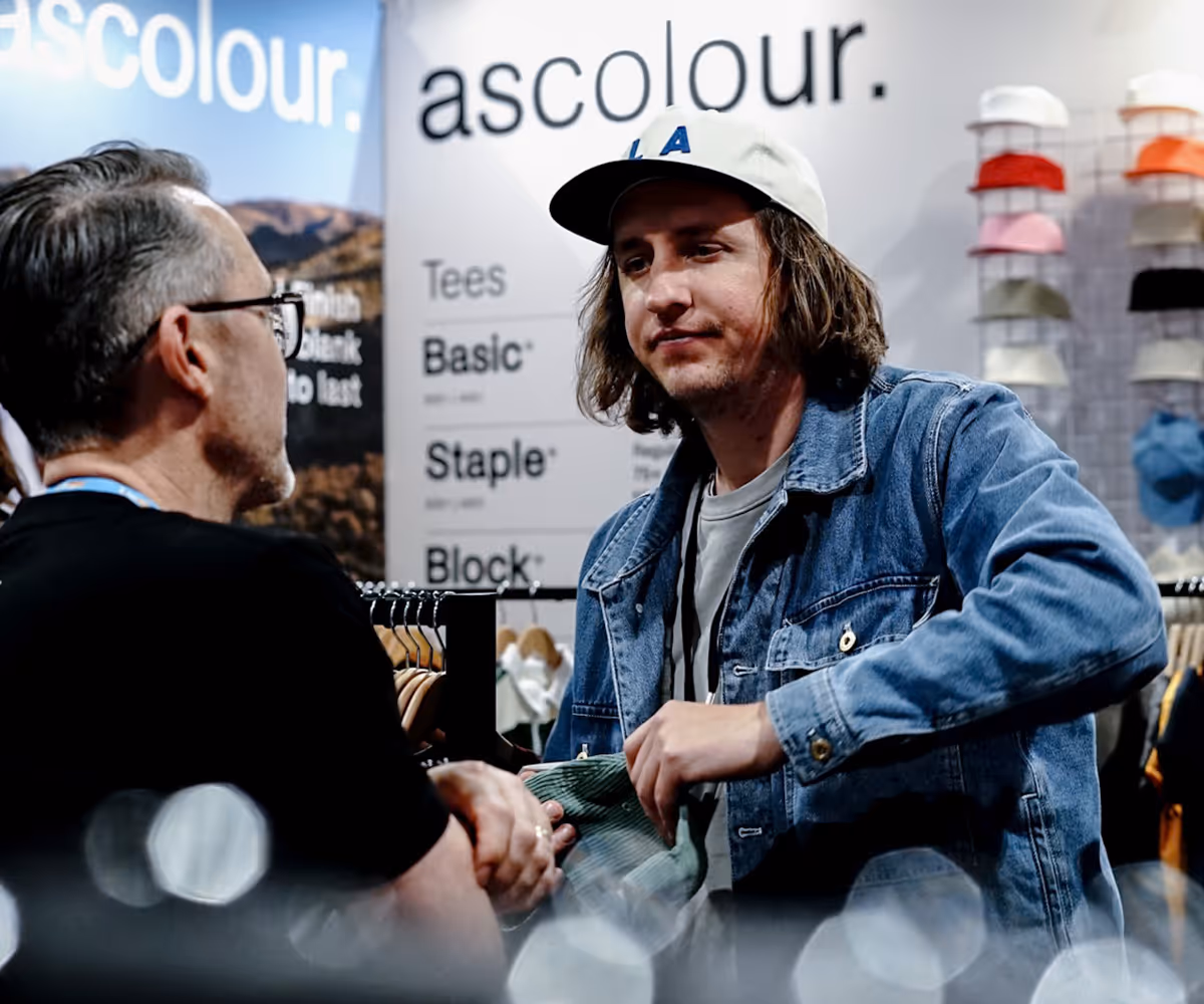 An image of an Apparel Graphics team member working with an AS Colour rep.