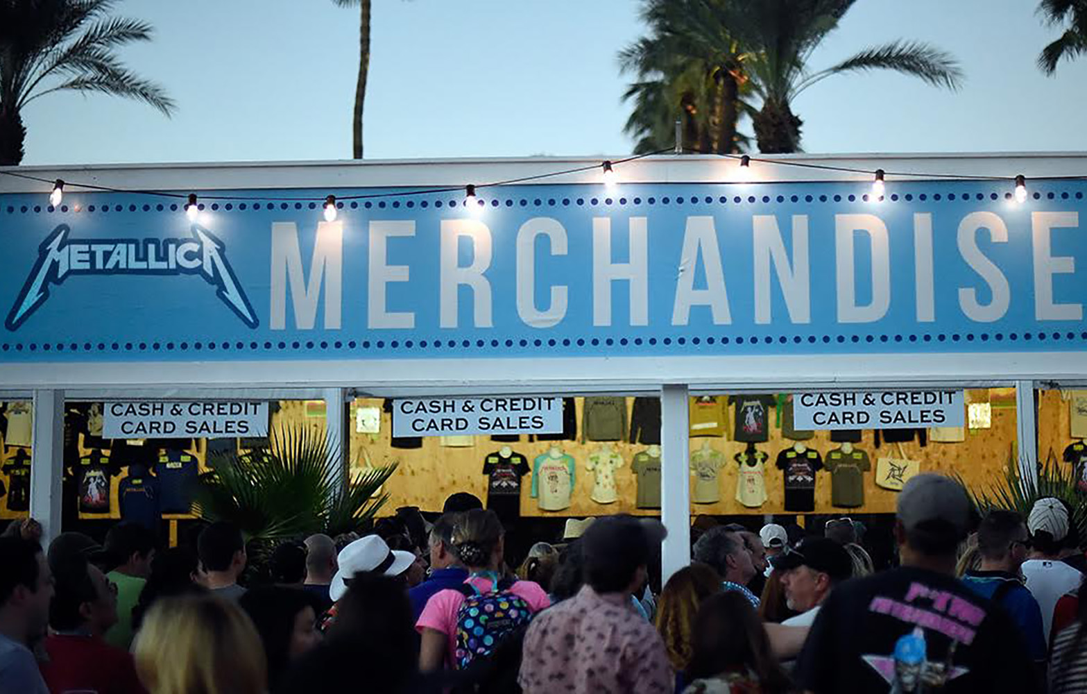 An image featuring the merch booth at a Metallica concert.