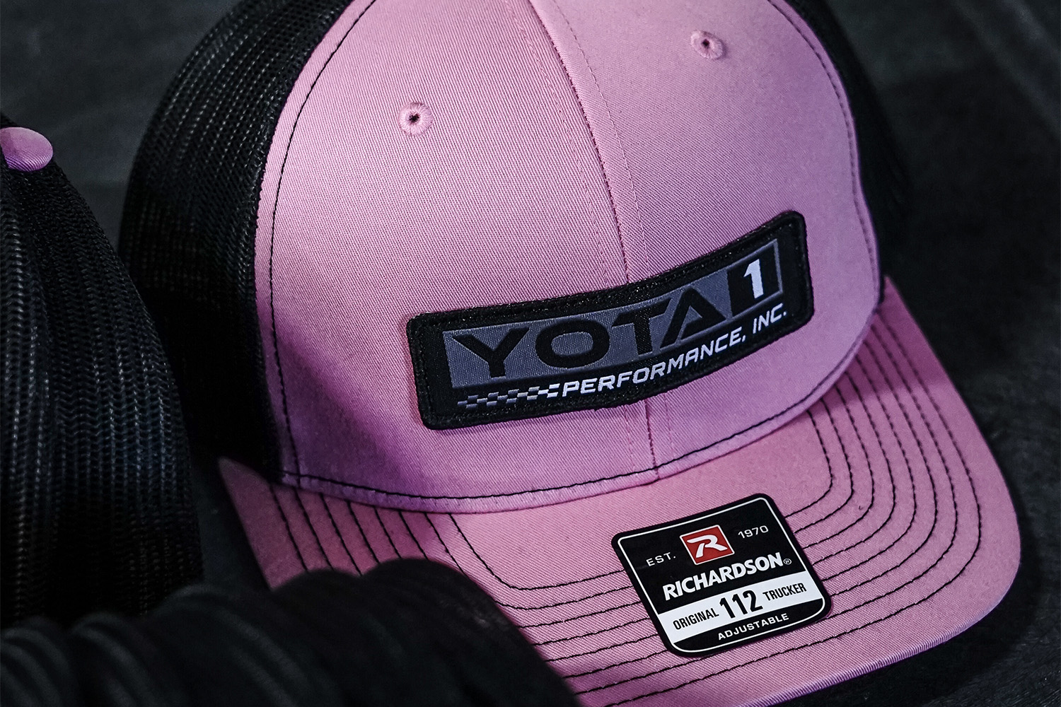 A custom trucker hat with a Toyota brand patch.