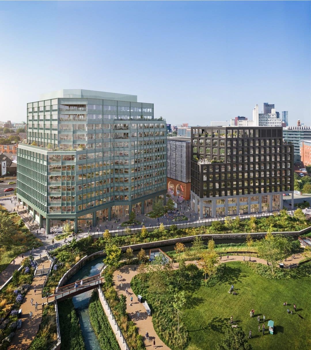 Aerial view of modern office buildings overlooking a landscaped urban park with walking paths and waterways.