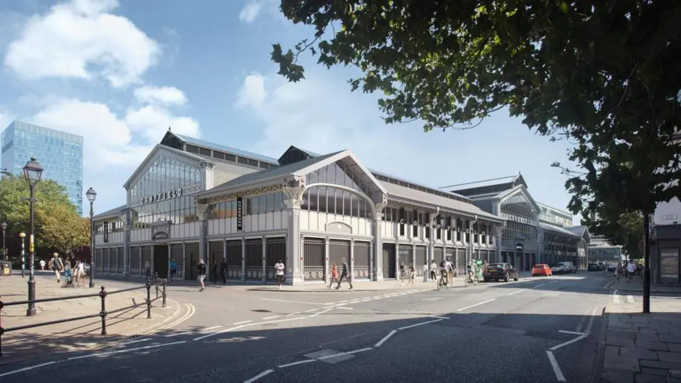 Exterior view of the historic Campfield Market Hall in Manchester, restored with modern detailing and surrounded by pedestrian activity.