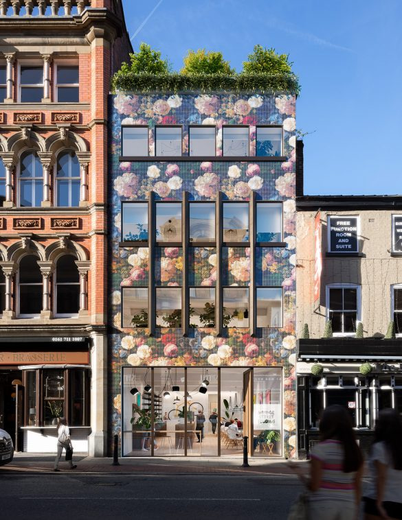 “Colourful floral-façade office building in Manchester with modern workspace visible through large street-level windows.