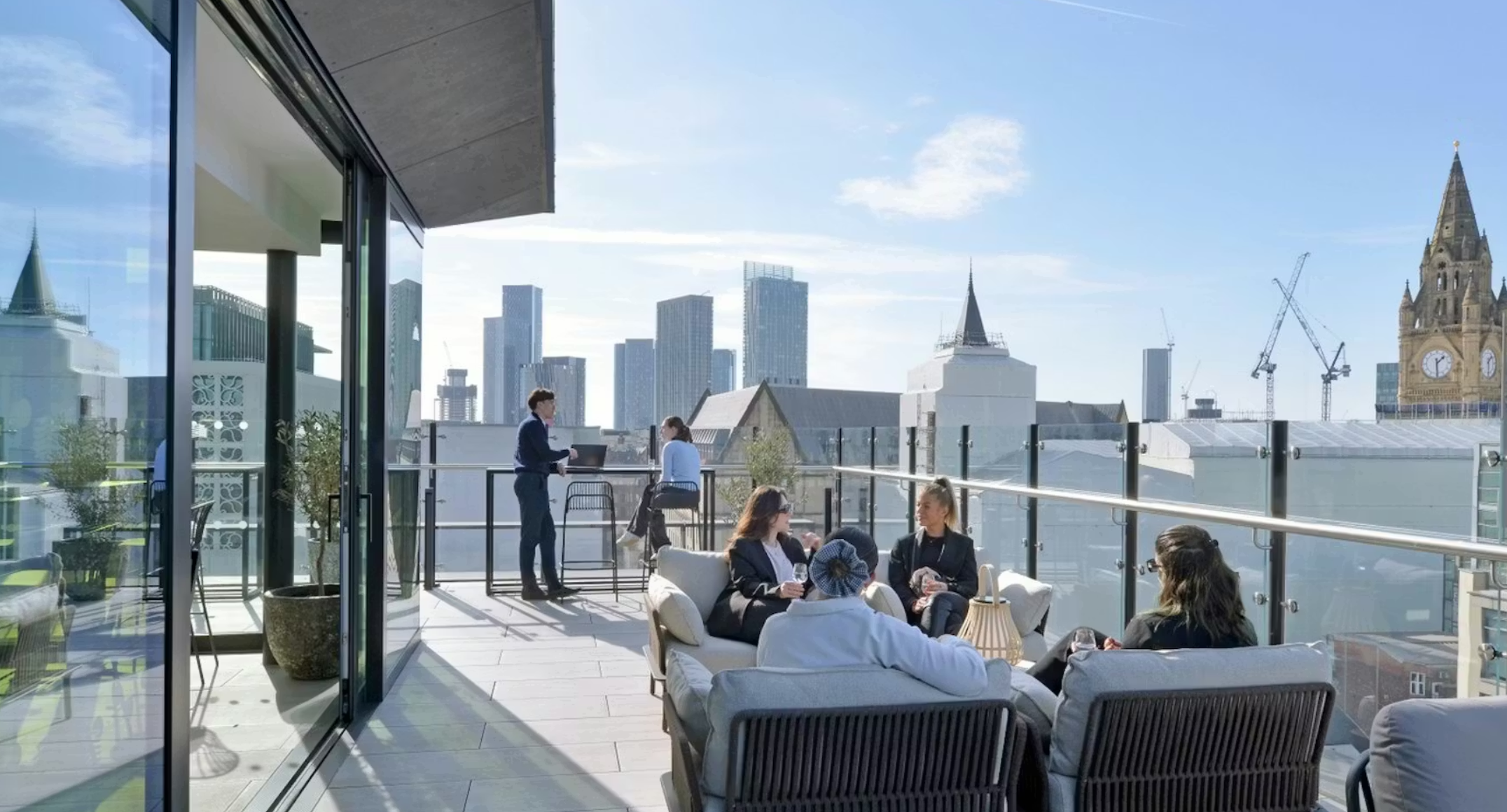 People on a balcony at Aviary, Manchester. Image credit: Aviary Manchester
