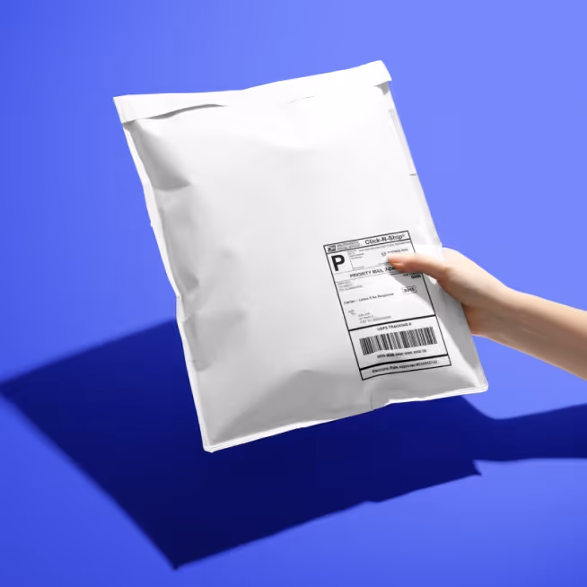 Image of a blank white mailer being held over a blue background