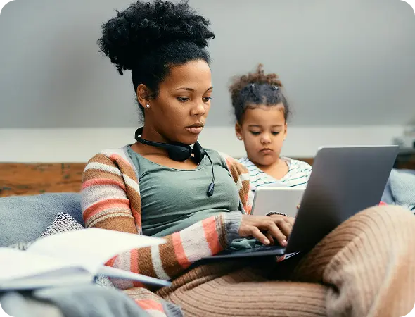 Young mother researching on laptop.