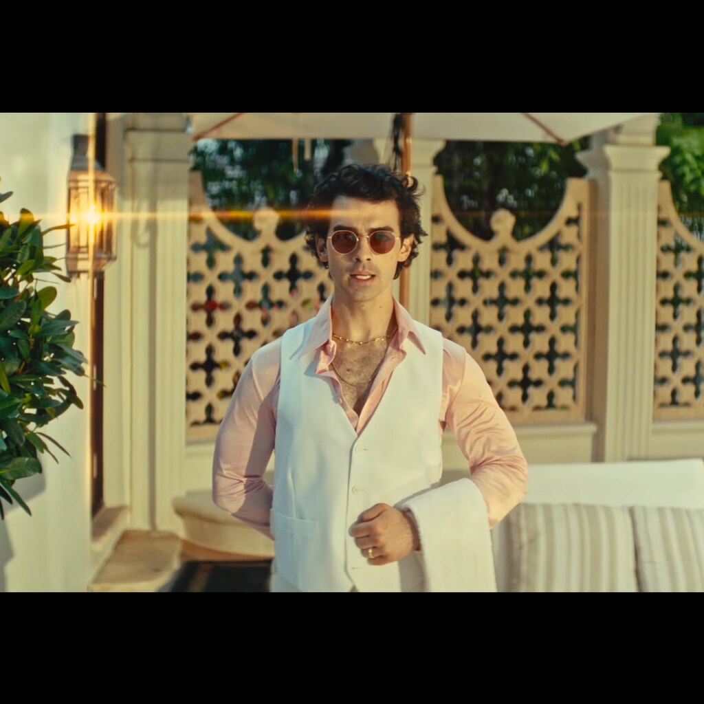 Joe Jonas by pool side in music video
