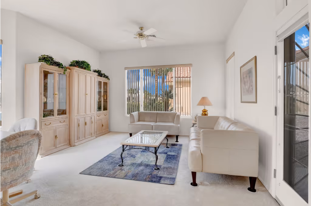 Charming single-story home with palm trees, stone walkway, landscaped yard, and warm twilight sky above the neighborhood street.