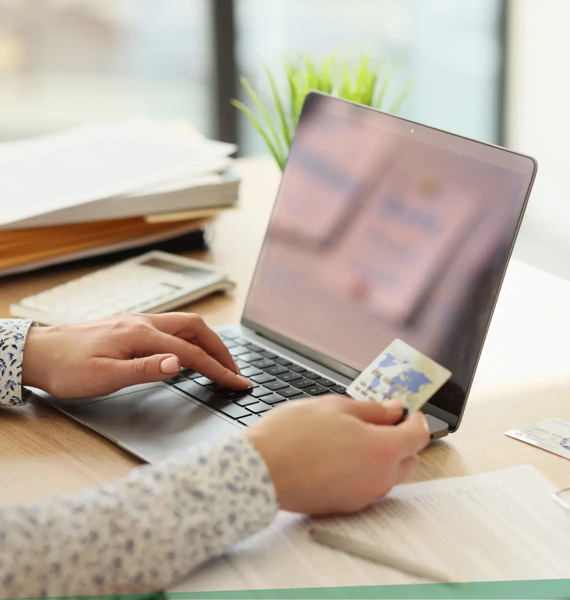 Person with credit card shopping online