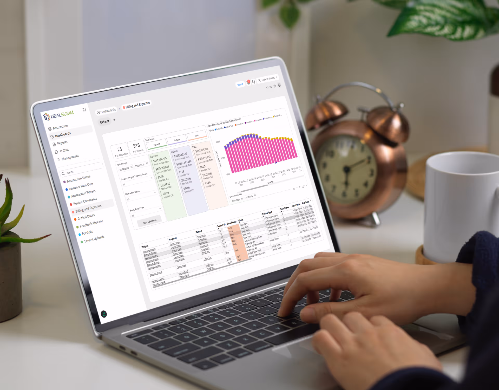 Person typing on a laptop displaying a DealSumm dashboard with charts and tables for billing and expenses management.