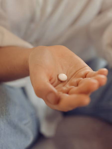 Image of hand holding abortion pill mifepristone