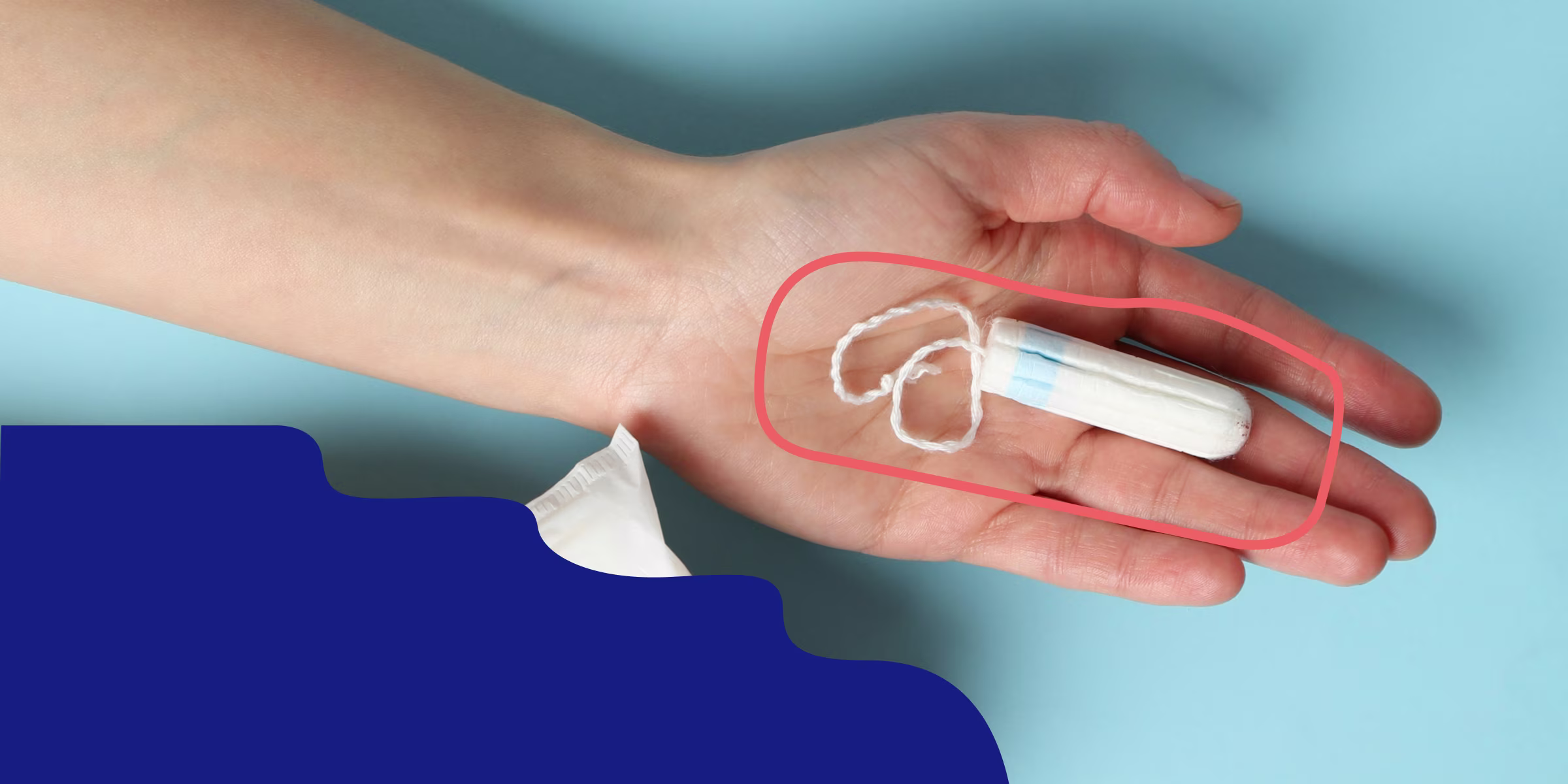 Image of a hand holding a tampon