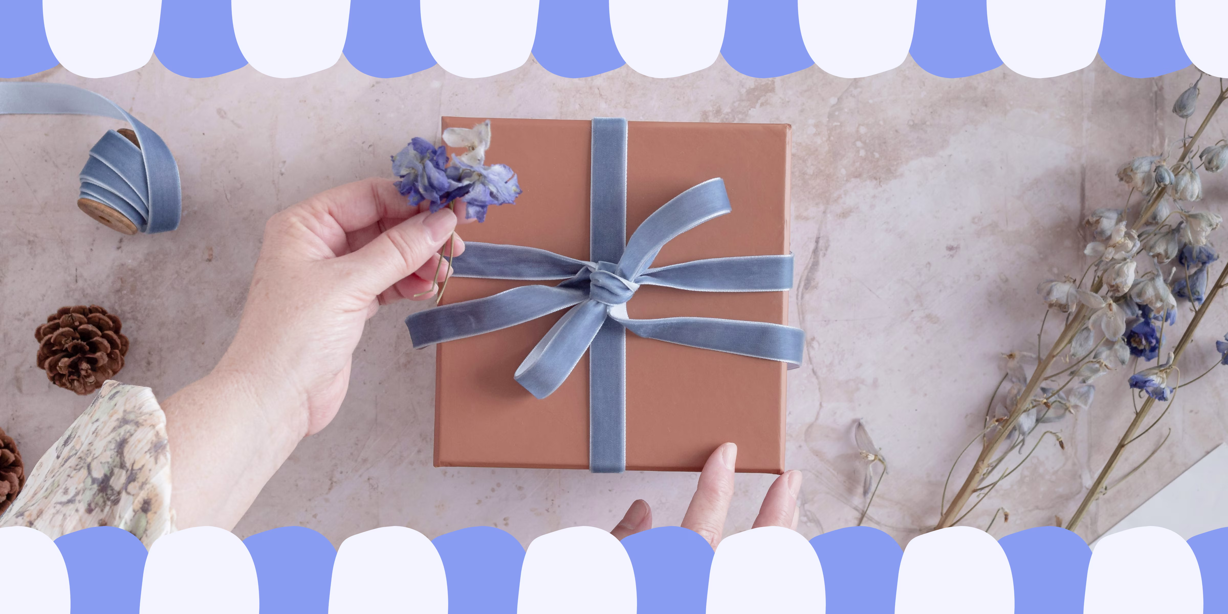Image of a present wrapped in brown paper and a blue ribbon.