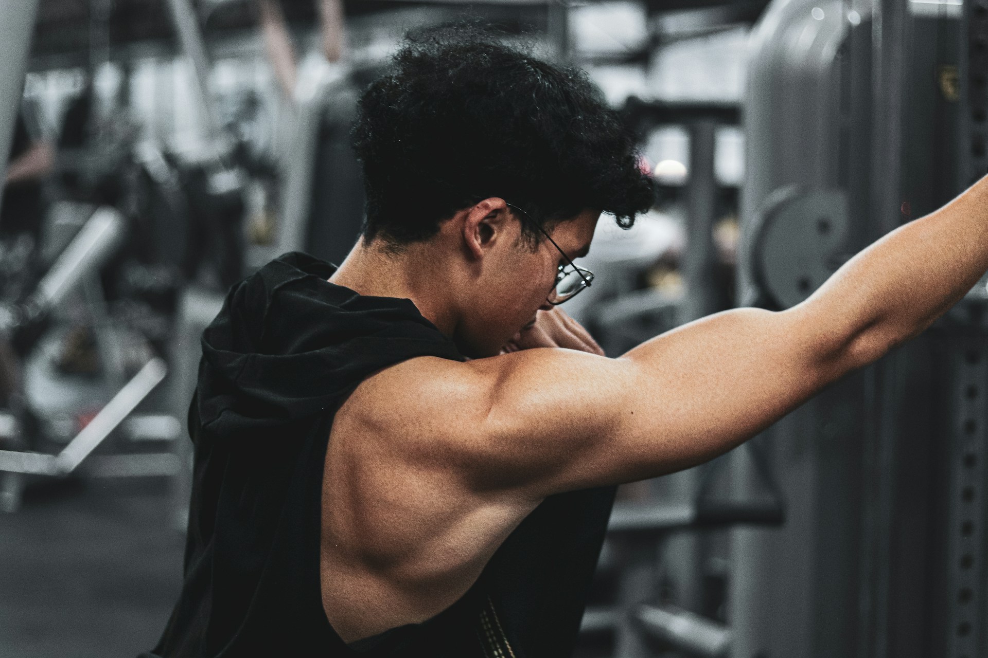 Man exercising at the gym with arm extended during a shoulder workout
