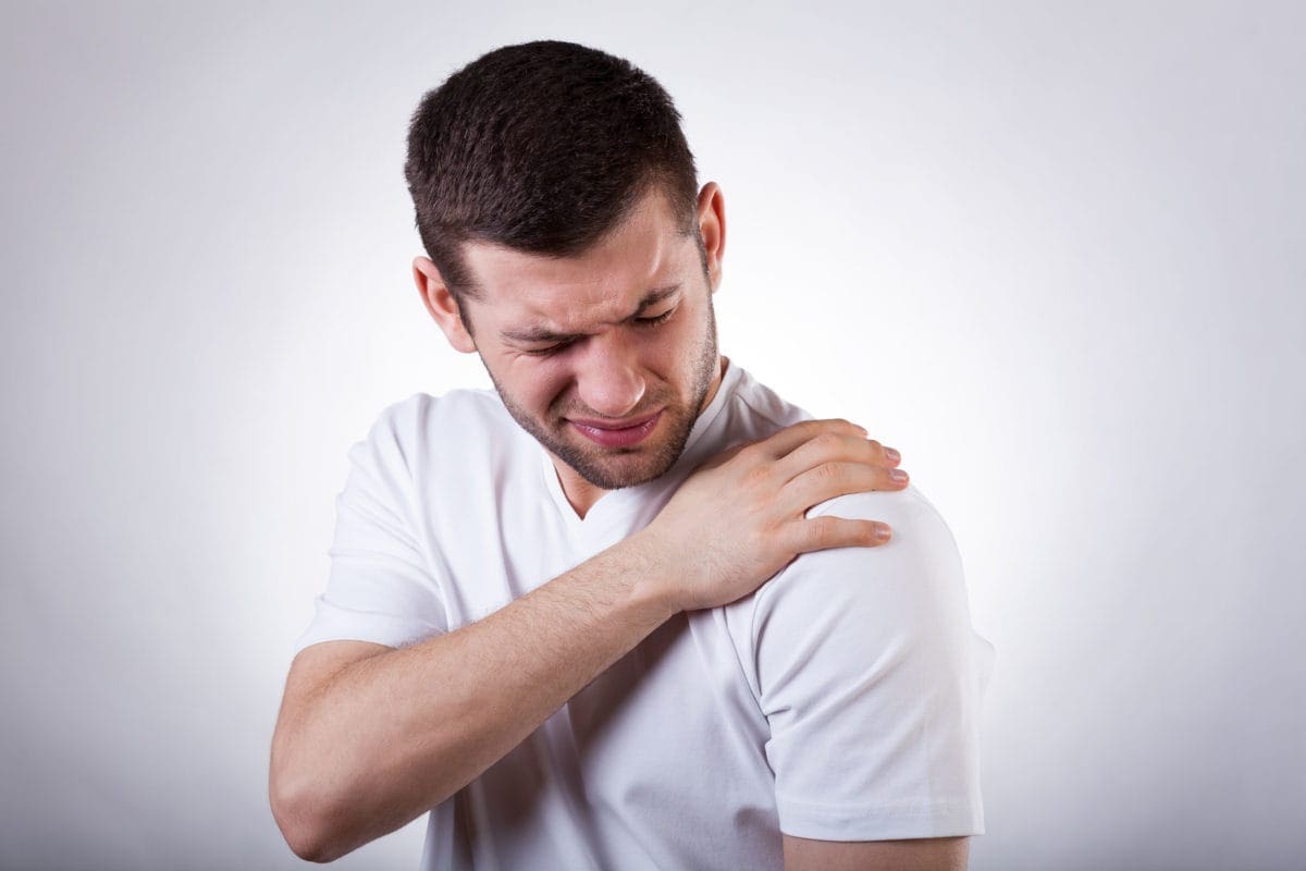 Younger patient discussing shoulder replacement options with a surgeon