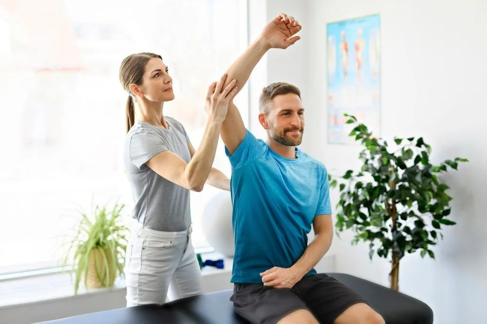 Patient performing a shoulder rehabilitation exercise with light resistance