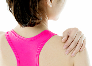 Woman holding her painful shoulder, a common sign of a torn labrum
