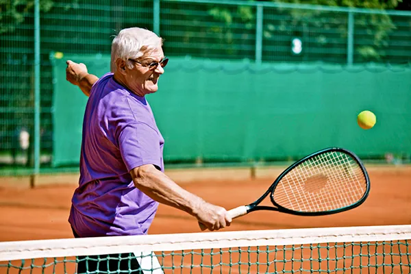 Person holding the outside of their elbow due to tennis elbow pain