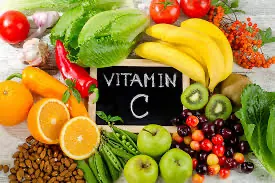 Fresh fruits and vegetables rich in vitamin C arranged around a "Vitamin C" label.