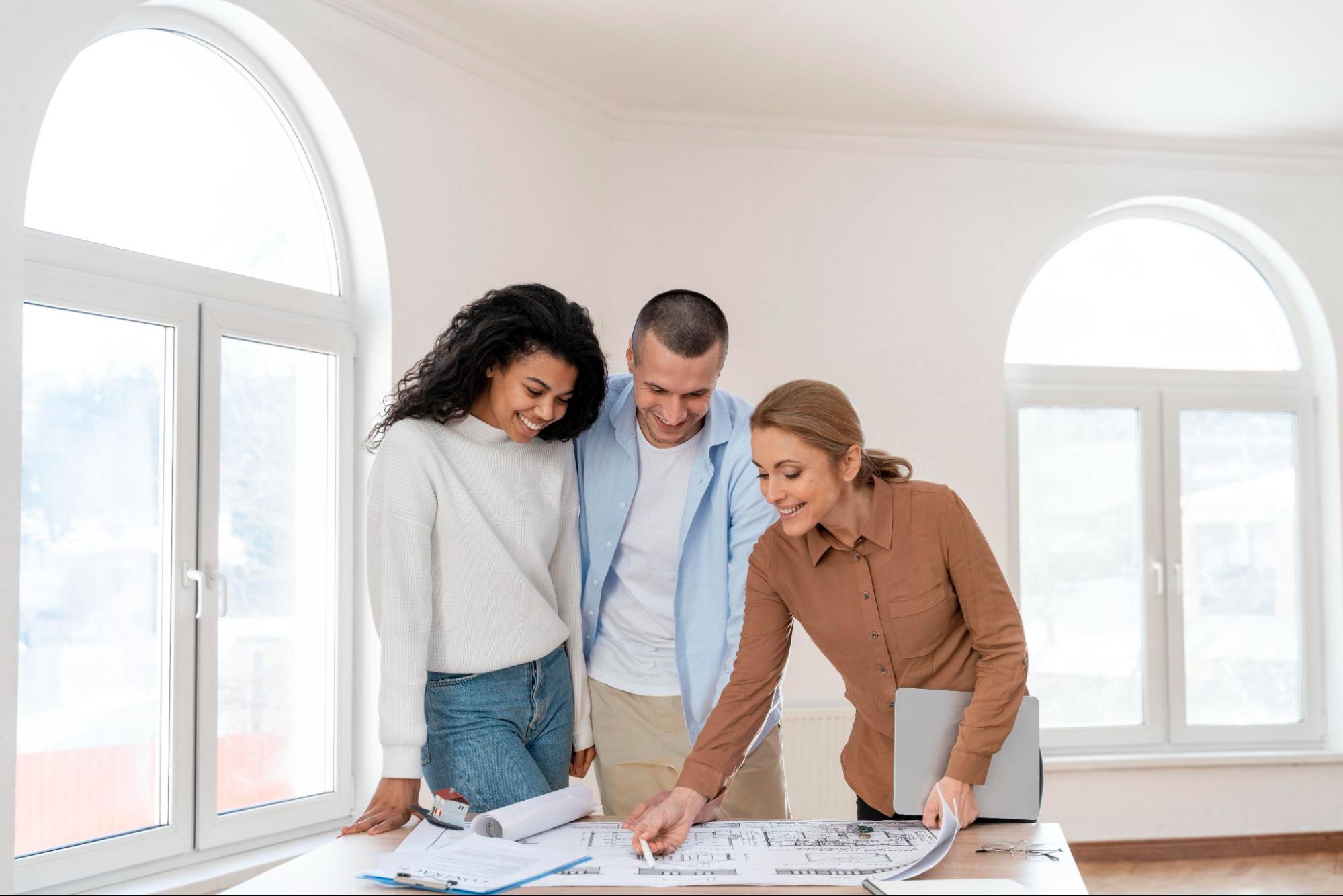 A mortgage broker with a family, signing property papers.‍