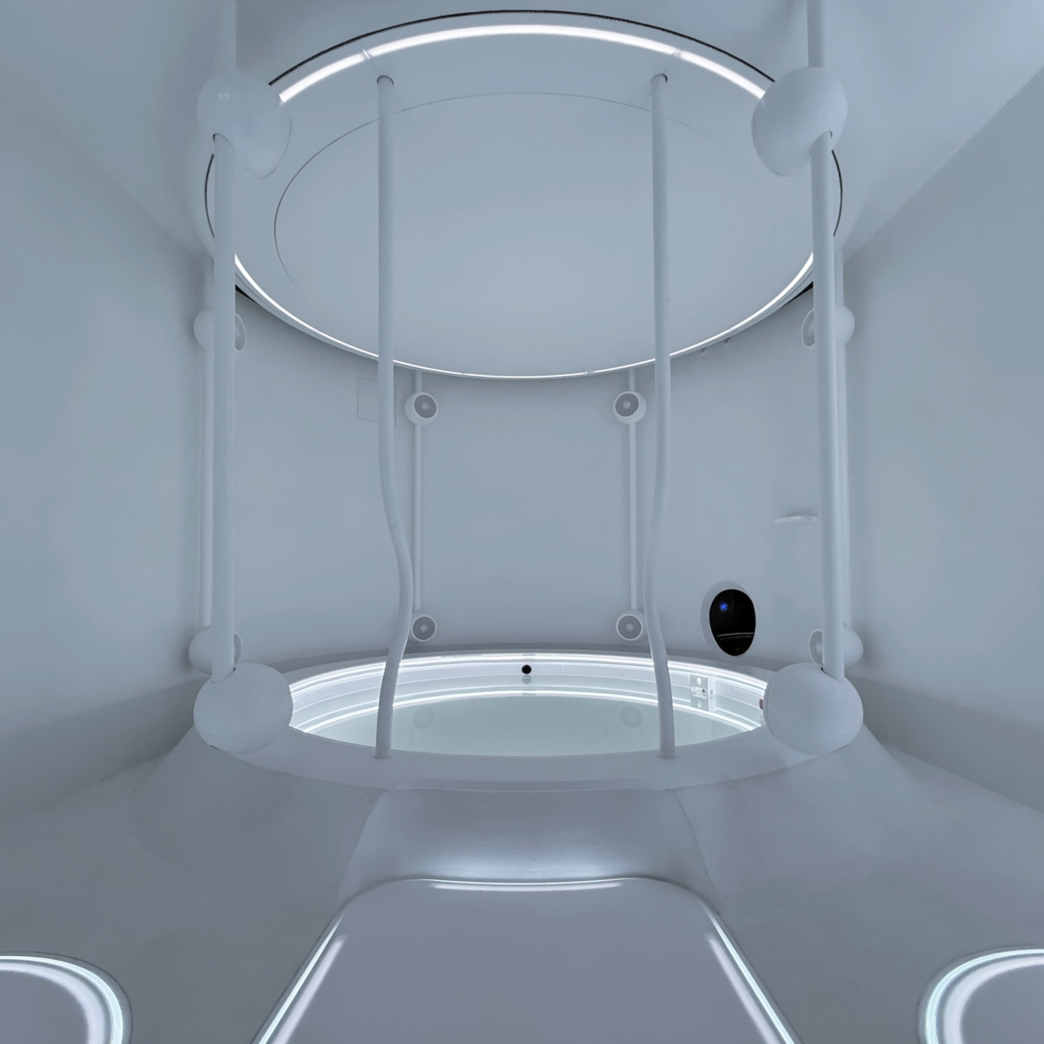 A man is floating and relaxing in the Wavess Origin Pool in a blue atmosphere