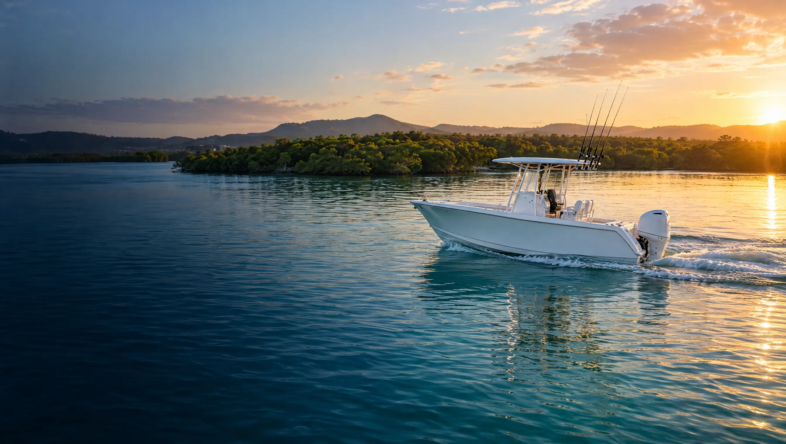 White centre console fishing boat cruising on calm turquoise water on a Gold Coast waterway at golden hour