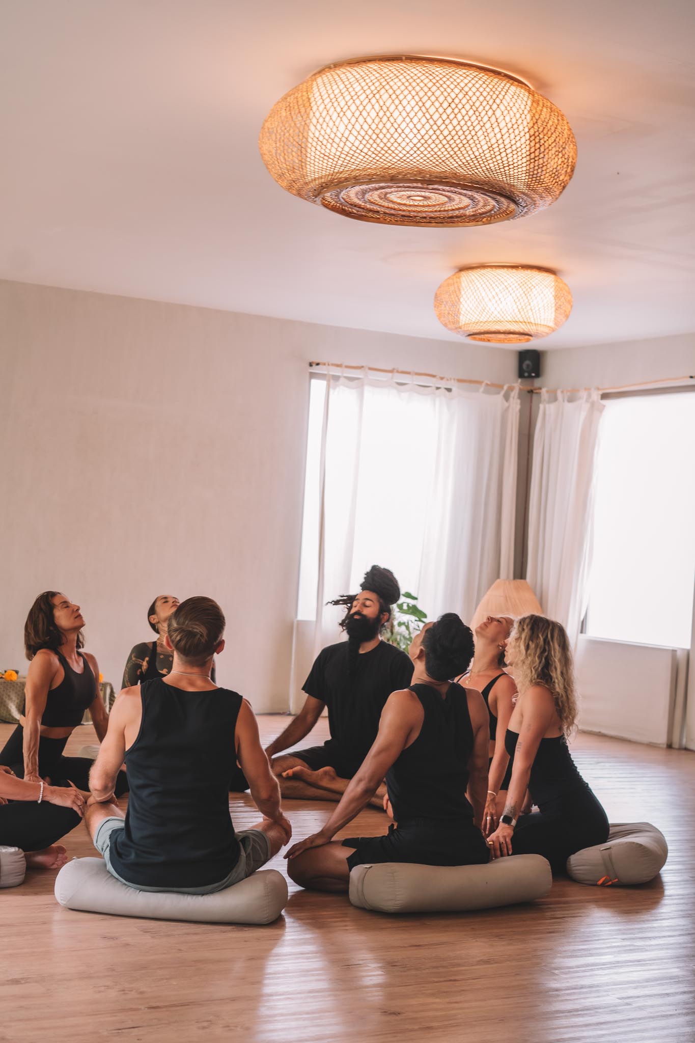 Yoga class seated together in a group circle at Path Yoga Center in Canggu, Bali