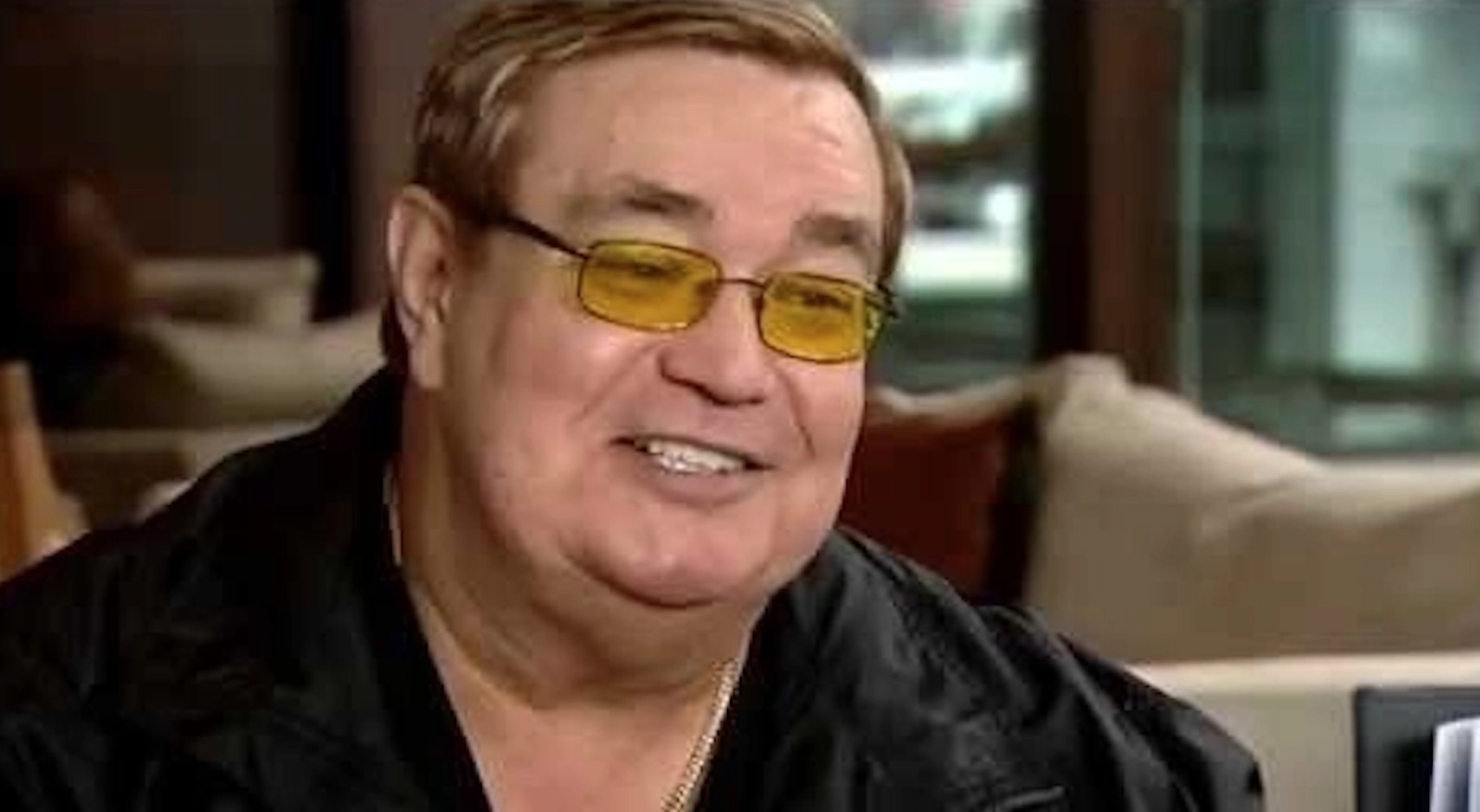 Bob Sheridan smiles while wearing yellow-tinted glasses.