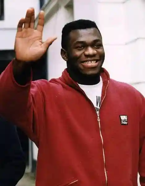 Herbie Hide smiling and waving in a red jacket