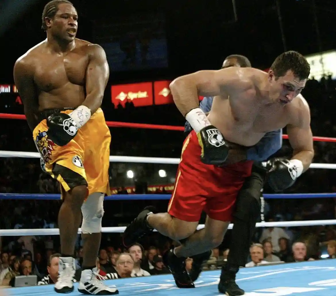 Lamon Brewster standing beside a falling opponent in the ring