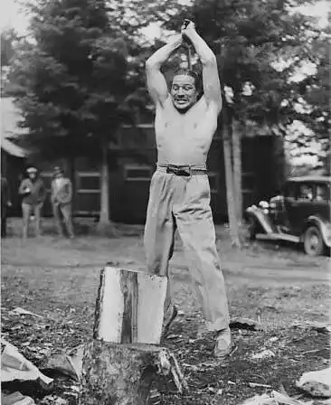 Max Baer outdoors with both arms raised above his head