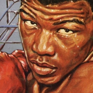 John Tate posing with boxing gloves in a black and white portrait