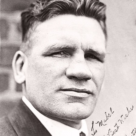 Black-and-white portrait of Gunboat Smith wearing a suit and tie