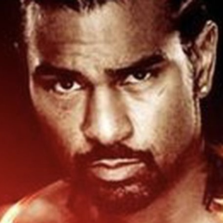 Portrait of British boxer David Haye facing the camera against a red background