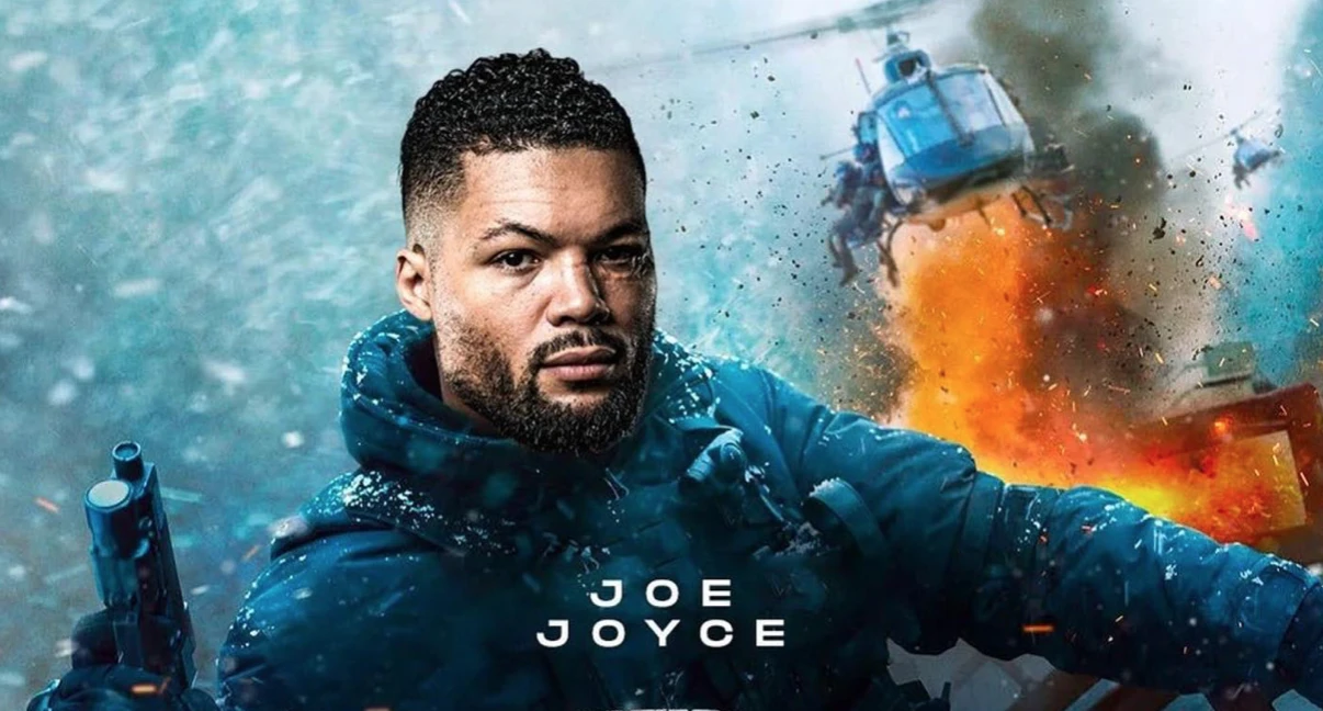 Joe Joyce depicted in an action-film-style graphic holding a handgun, with an explosion and helicopter behind him.