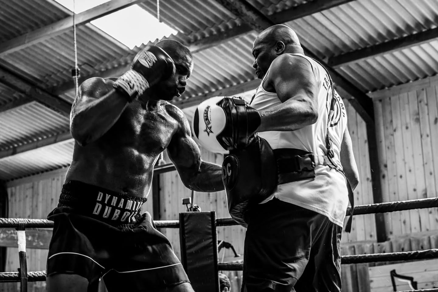 Daniel Dubois working with a trainer wearing a body protector during a gym session.