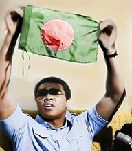 Muhammad Ali holds the Bangladesh flag above his head.