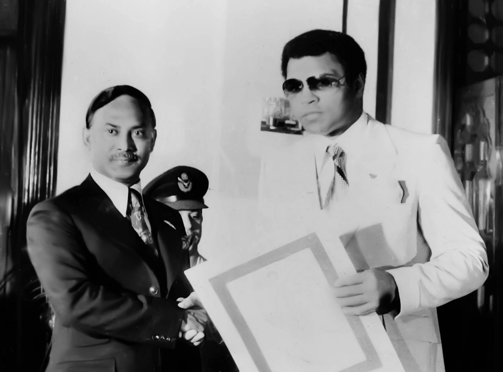 President Ziaur Rahman and Muhammad Ali hold a framed presentation during Ali’s 1978 visit to Bangladesh.