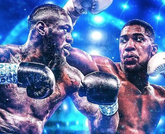 Promotional composite of Deontay Wilder and Anthony Joshua wearing boxing gloves against blue arena lights.