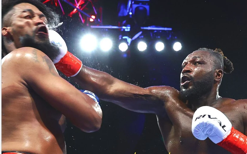 Jeremiah Milton lands a punch on Craig Lewis in the ring.