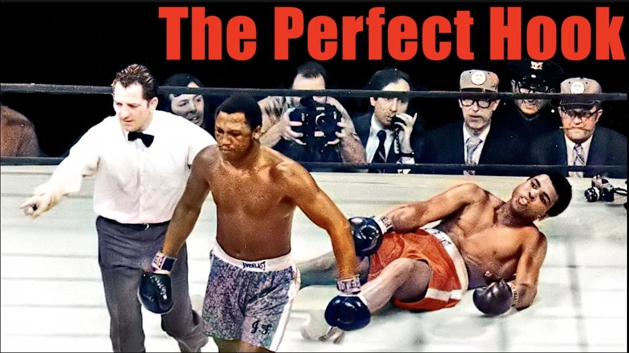 Video thumbnail titled The Perfect Hook showing Joe Frazier walking away as Muhammad Ali falls to the canvas.