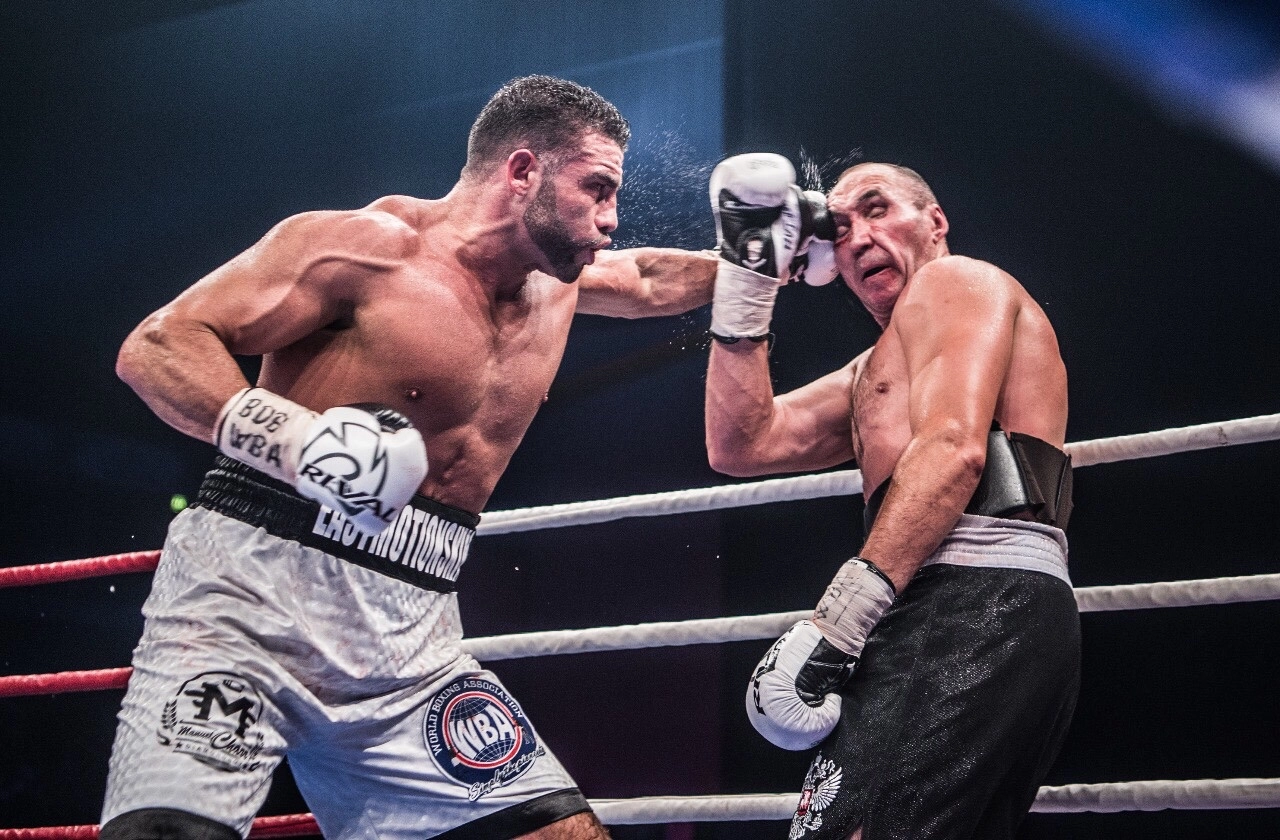 Mahmoud Charr lands a left hand on an opponent near the ropes.