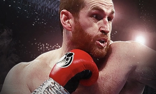 David Price wearing red boxing gloves in the ring.