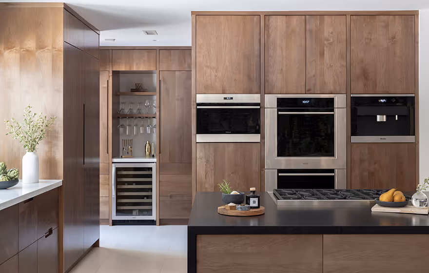Dramatic woodgrain kitchen cabinets in remodeled kitchen.