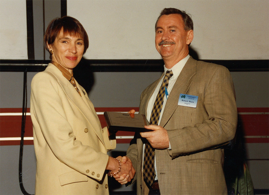 1198 man and woman holding award