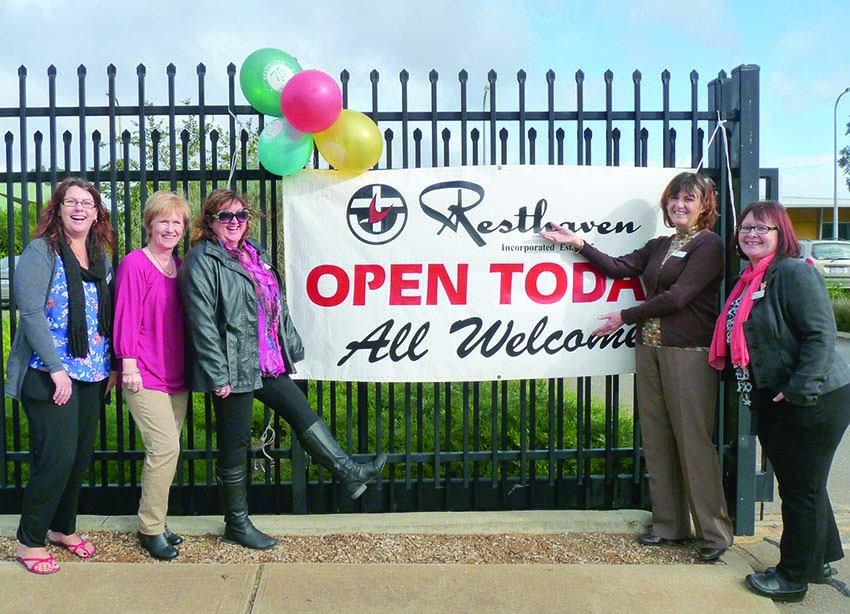 group of ladies standing in front of Open Day sign