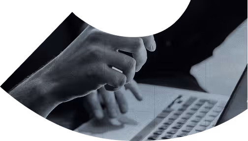 Close-up of a person's hands typing on a laptop keyboard.