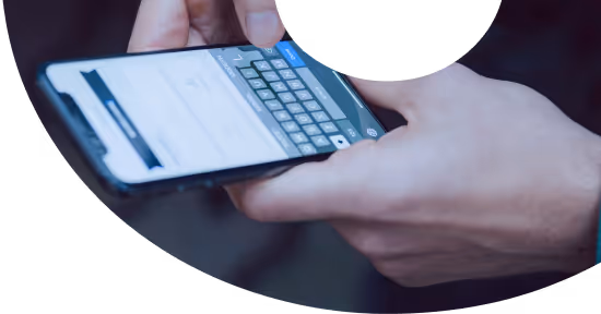 Person typing on a smartphone with an on-screen keyboard visible.