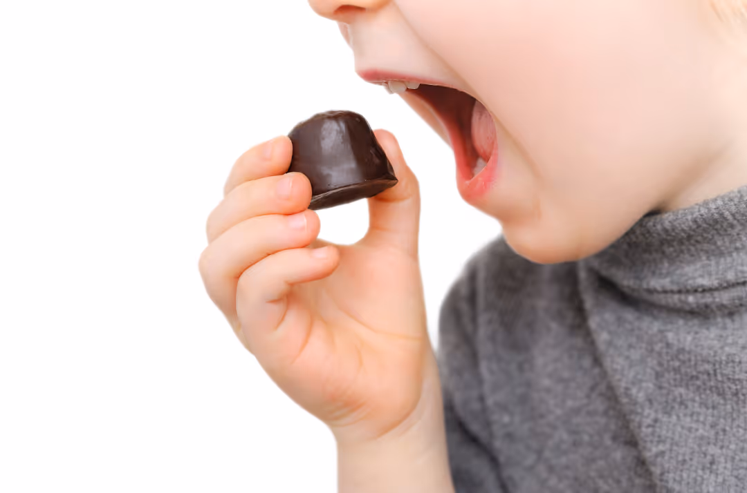 A child eating a chocolate candy